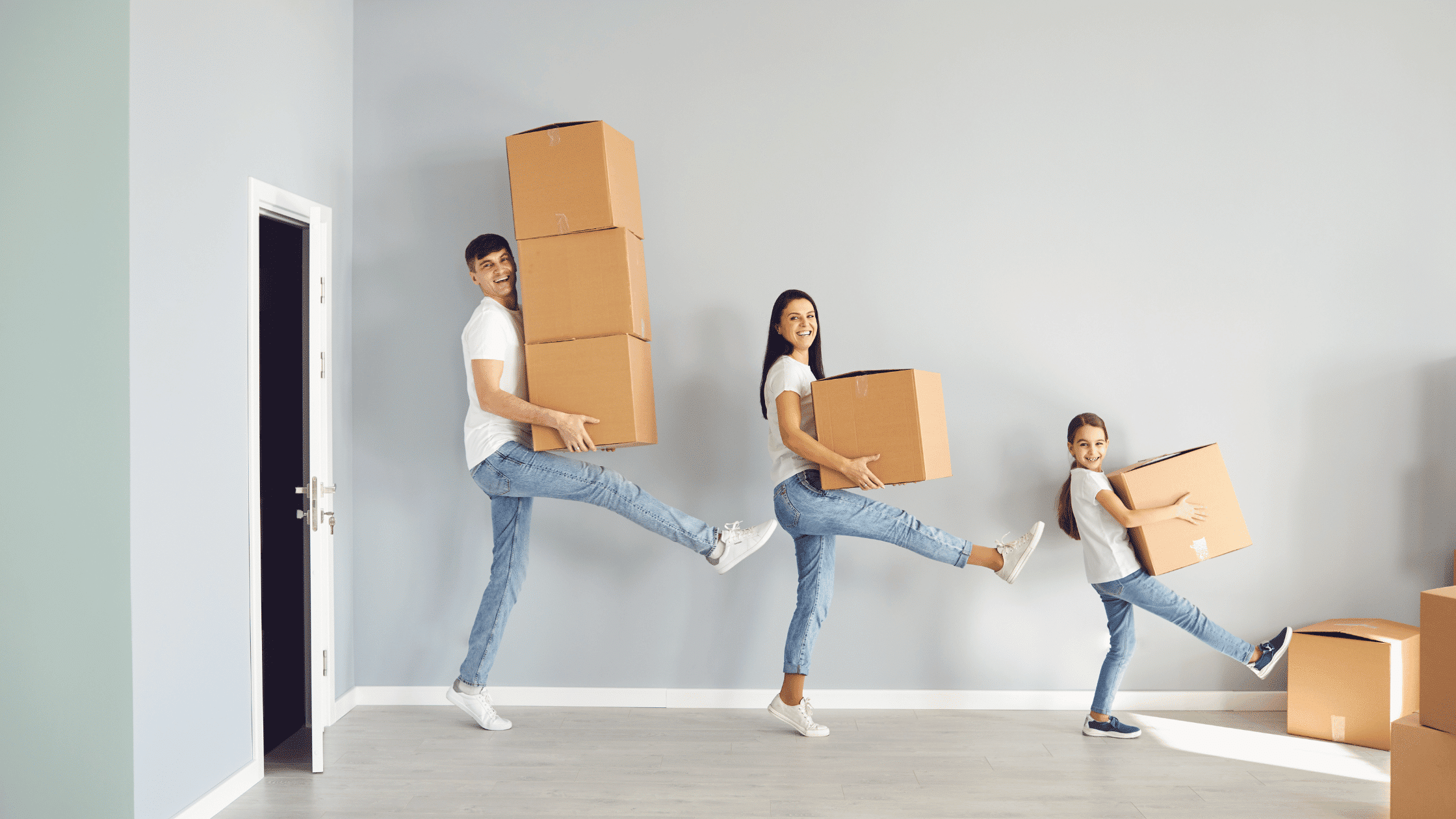 Picture of a family happily carrying boxes to represent geoarbitrage, the act of moving to save money