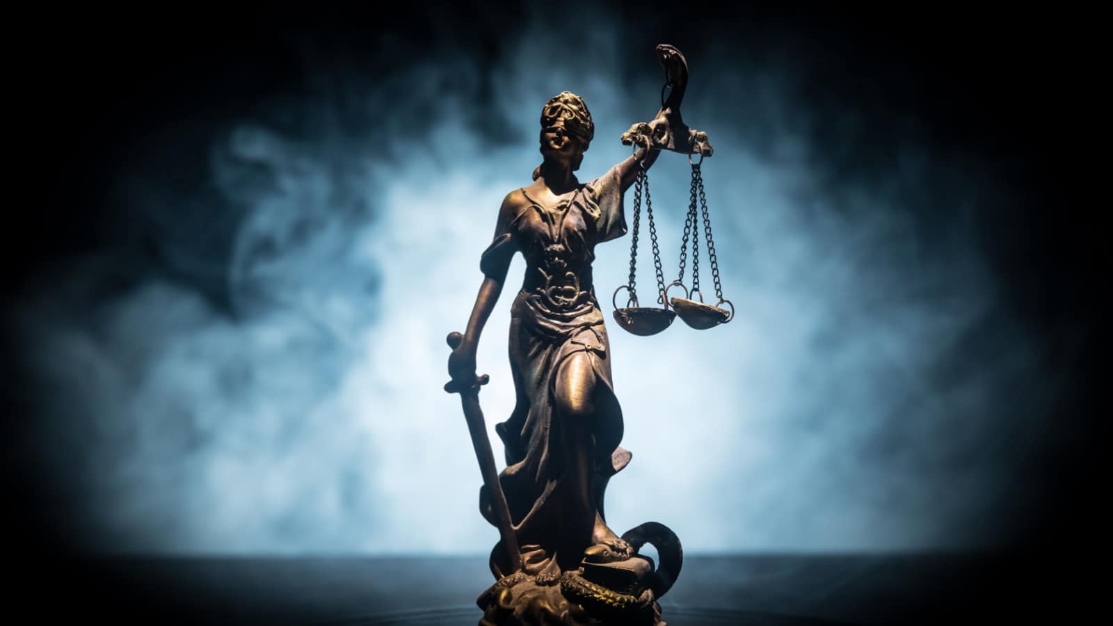 Statue of Justice concept on a stormy background to represent the Just World Fallacy
