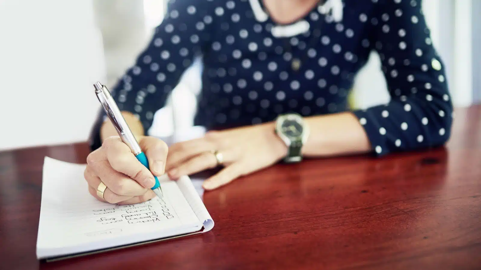 A woman crossing items off her to-do list. 