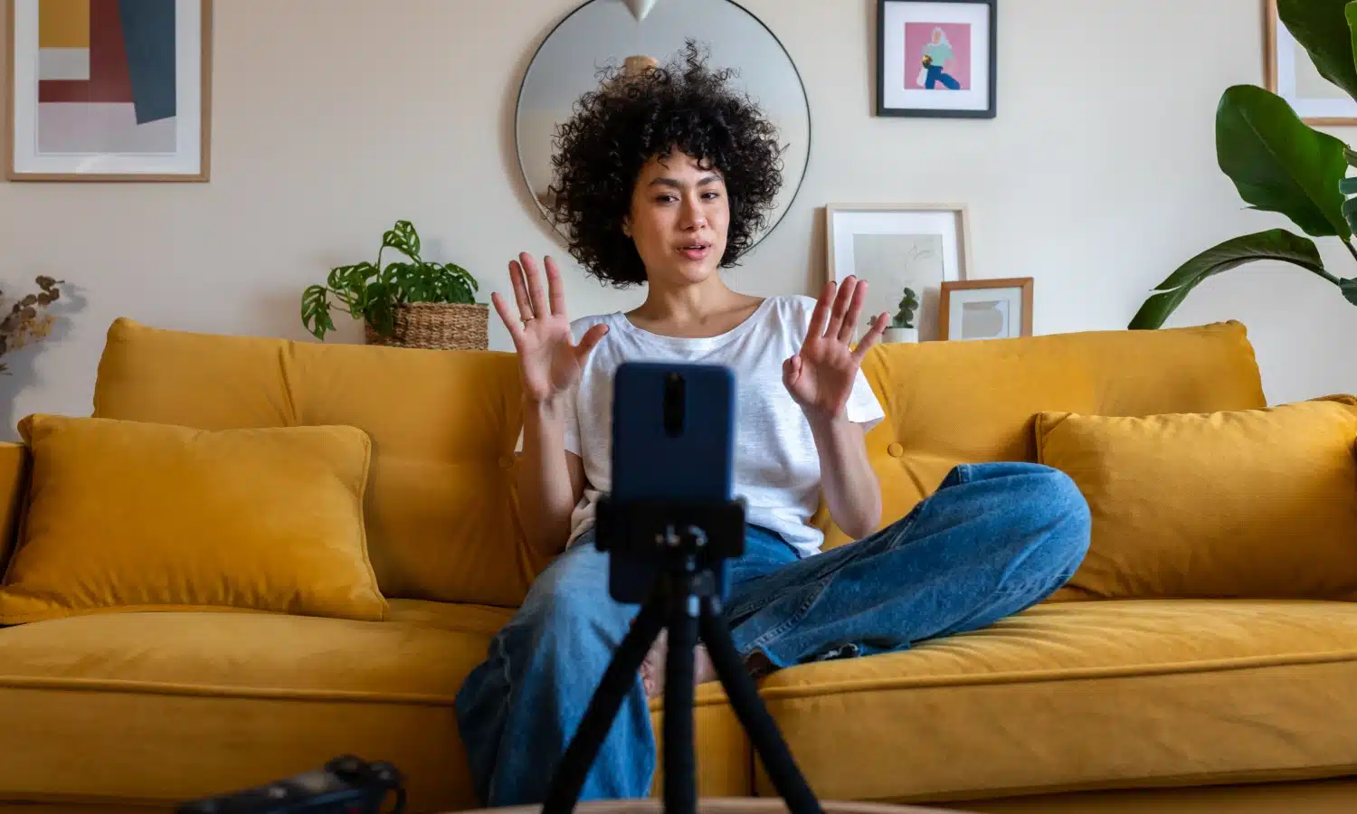A woman making a video as she works on her side hustle. 