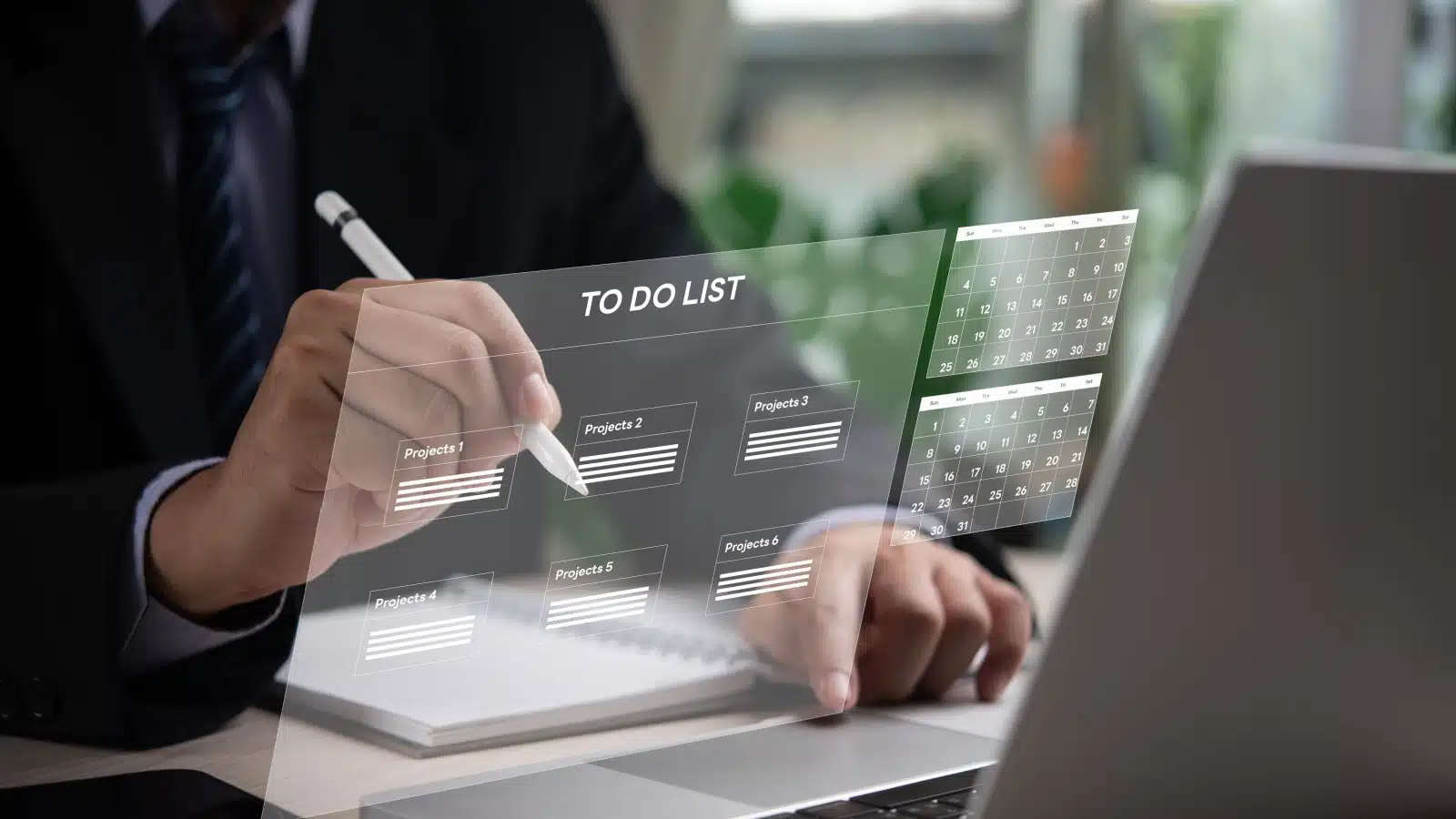A man making a list with technology to keep track of his projects. 