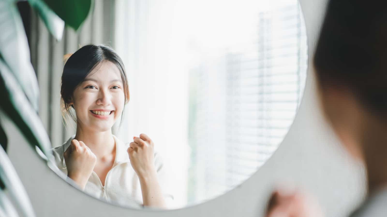 A woman showing strength in a mirror to represent self-advocacy or advocating for yourself.