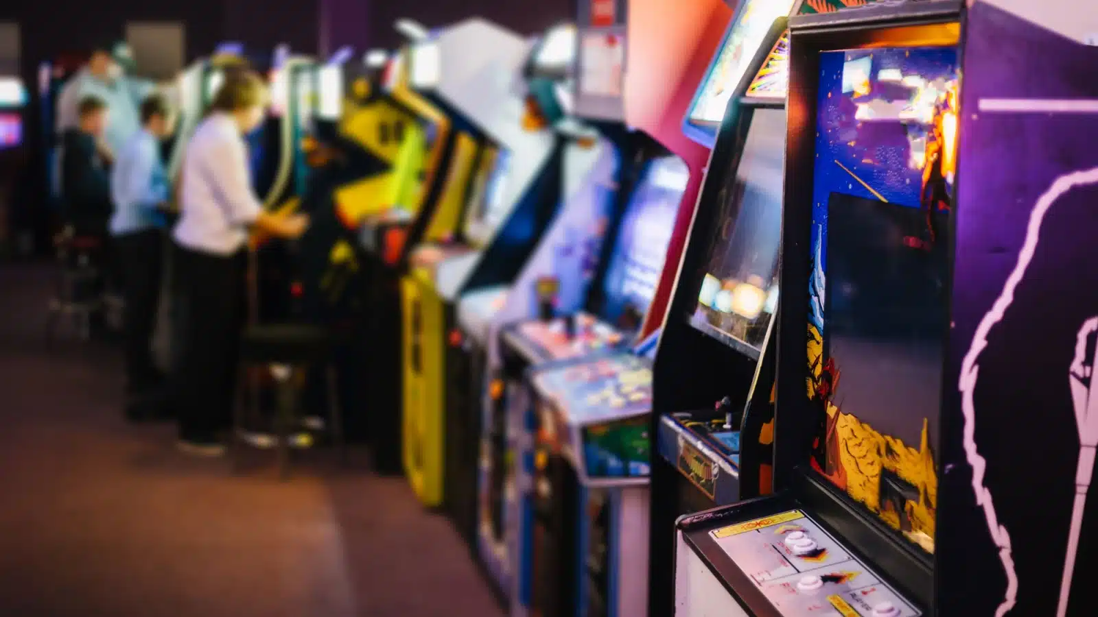 A row of vintage arcade game cabinets. 
