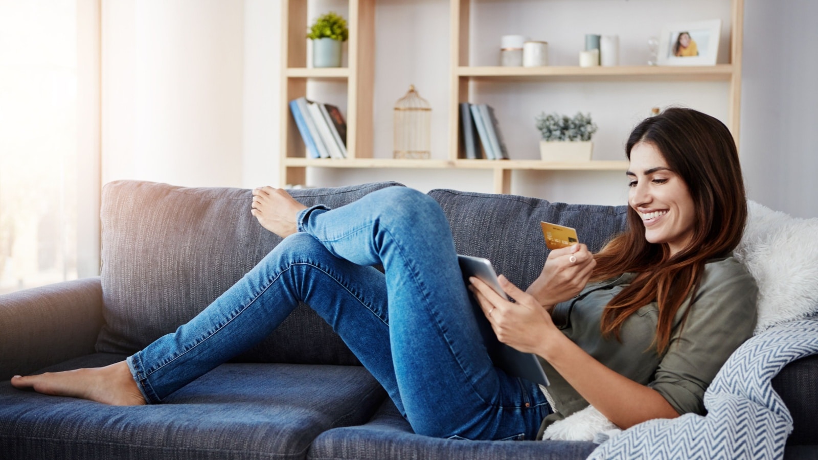 A woman shopping online with a tablet to represent alternatives to Amazon.