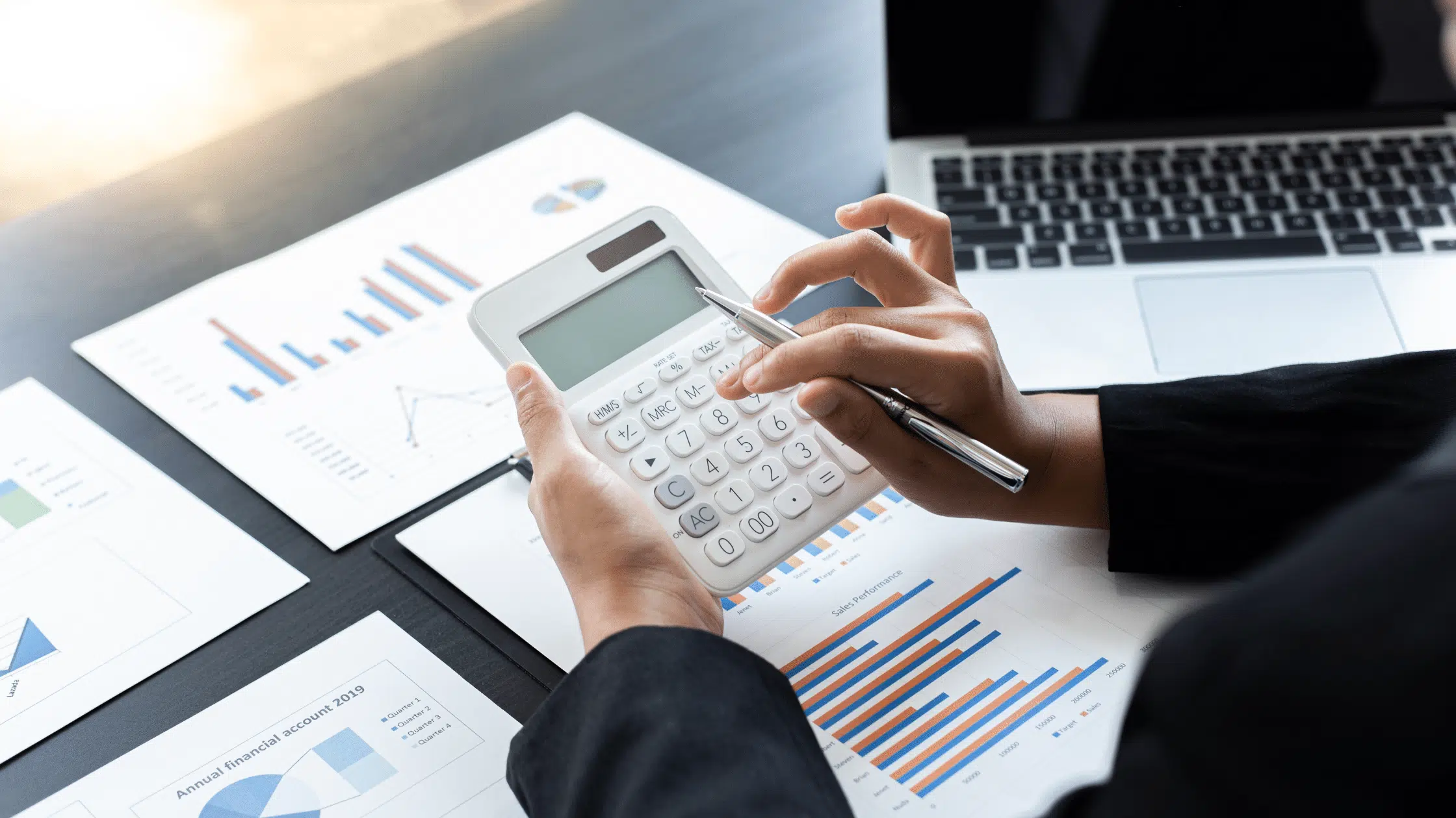 person using a calculator to represent financial literacy