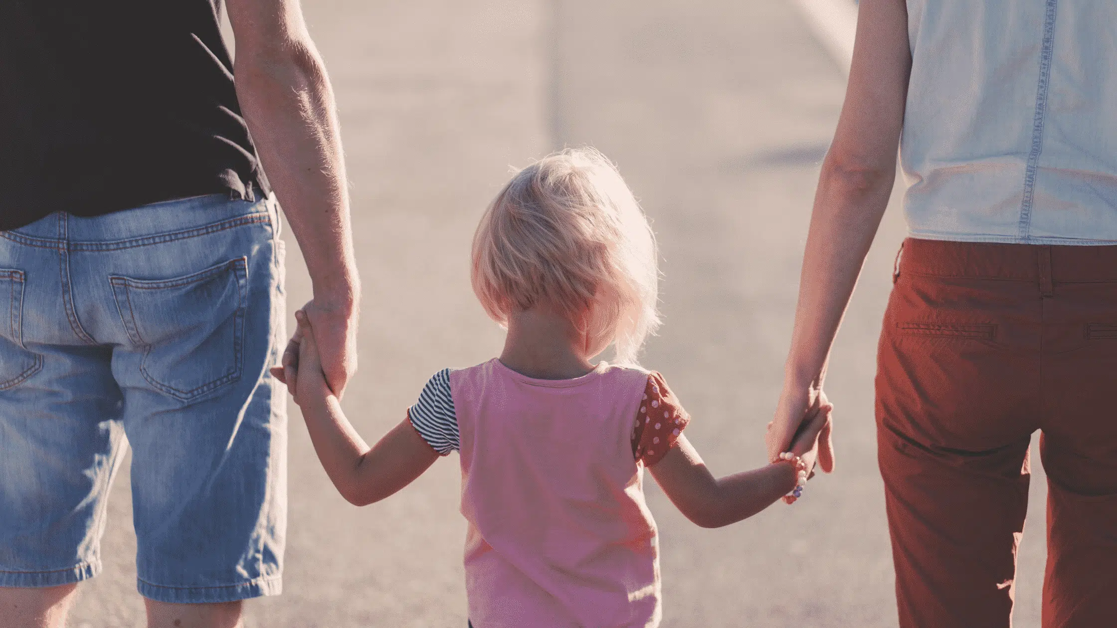 image of parents holding a little girl's hands to represent parenting books