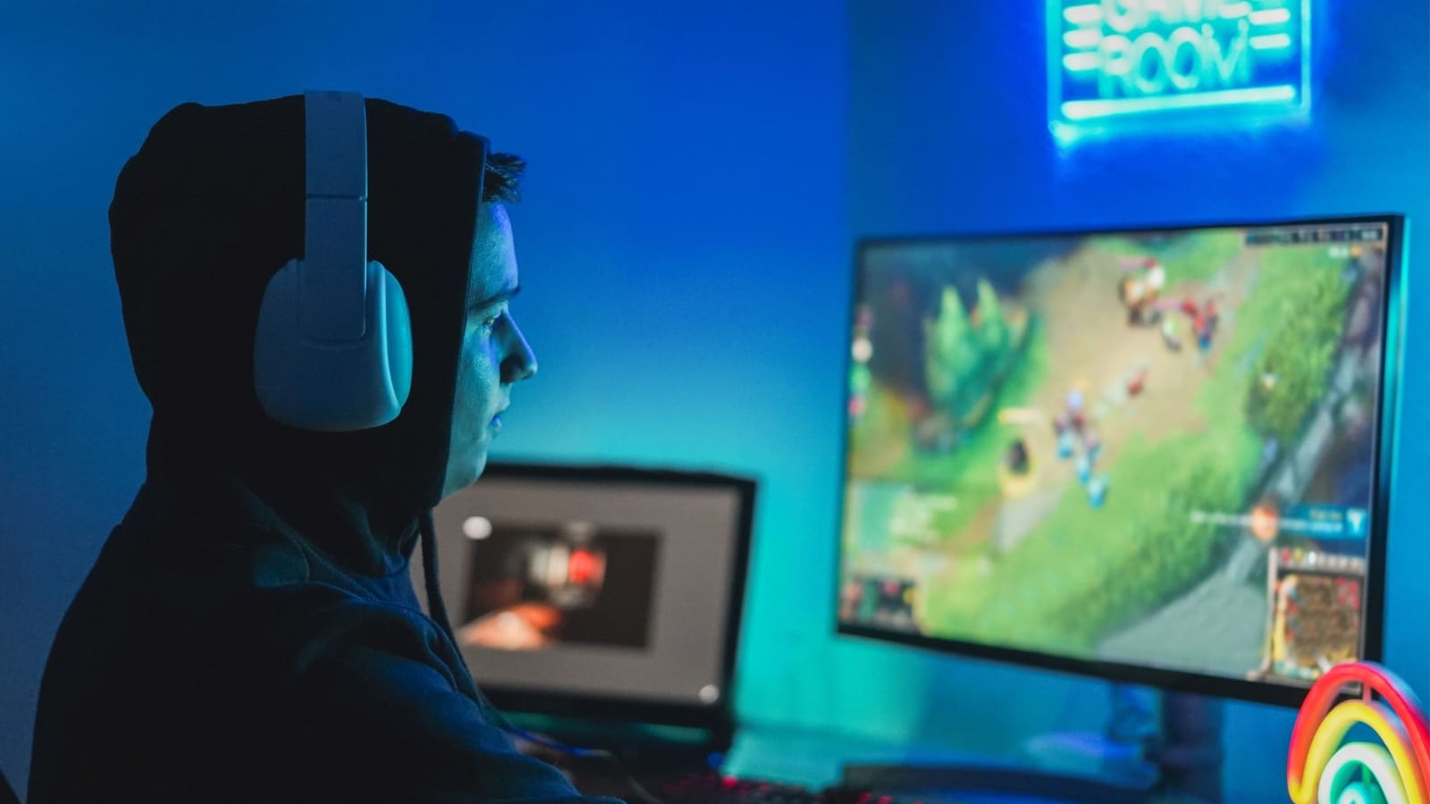 A young man gaming on his computer to representing how to get viewers on Twitch.