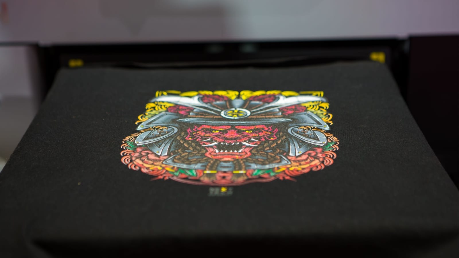 A professional sublimation printer printing graphics on a t-shirt.