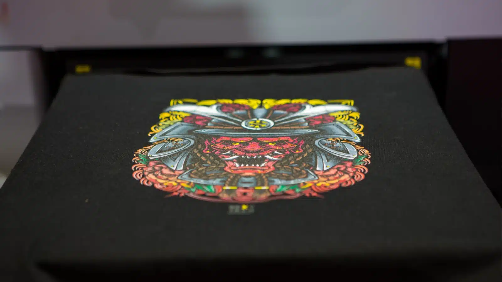 A professional sublimation printer printing graphics on a t-shirt.