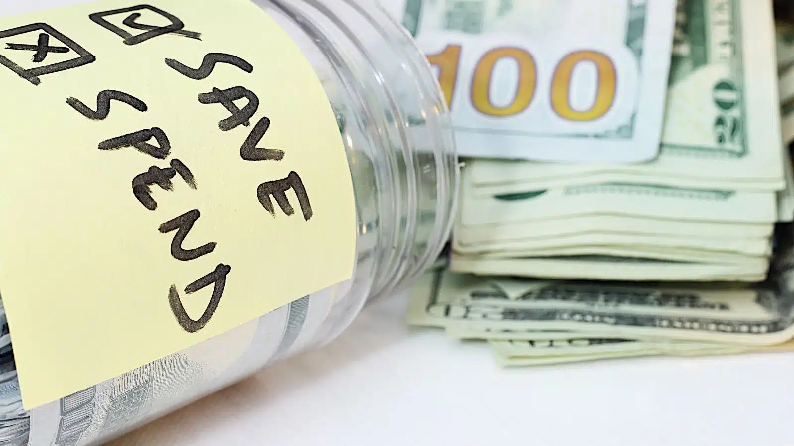 A money jar with an X in the spend column and a checkmark in the save column to represent saving over spending. 