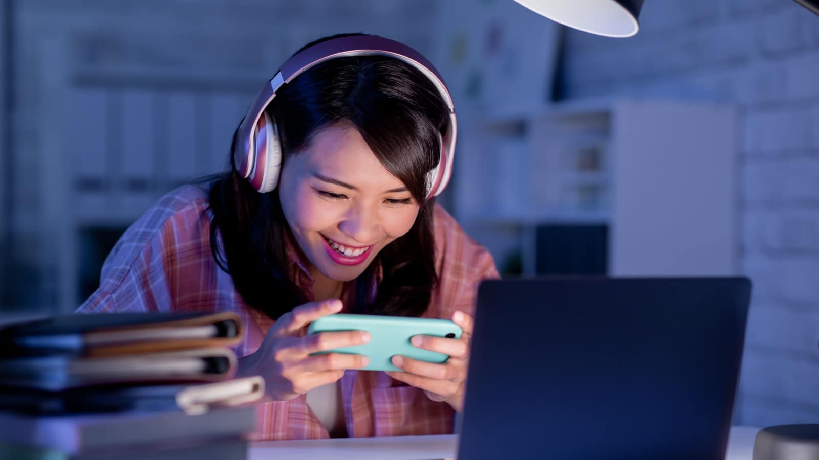 A woman playing a fun game on her cell phone to represent Discord bots that offer games.