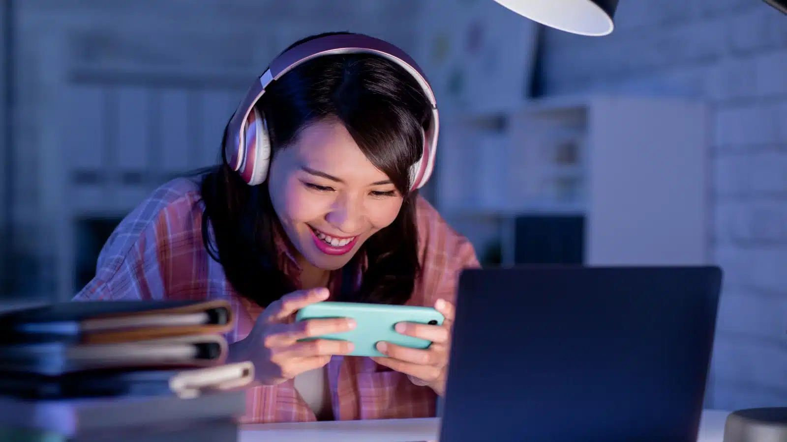A woman playing a fun game on her cell phone to represent Discord bots that offer games. 