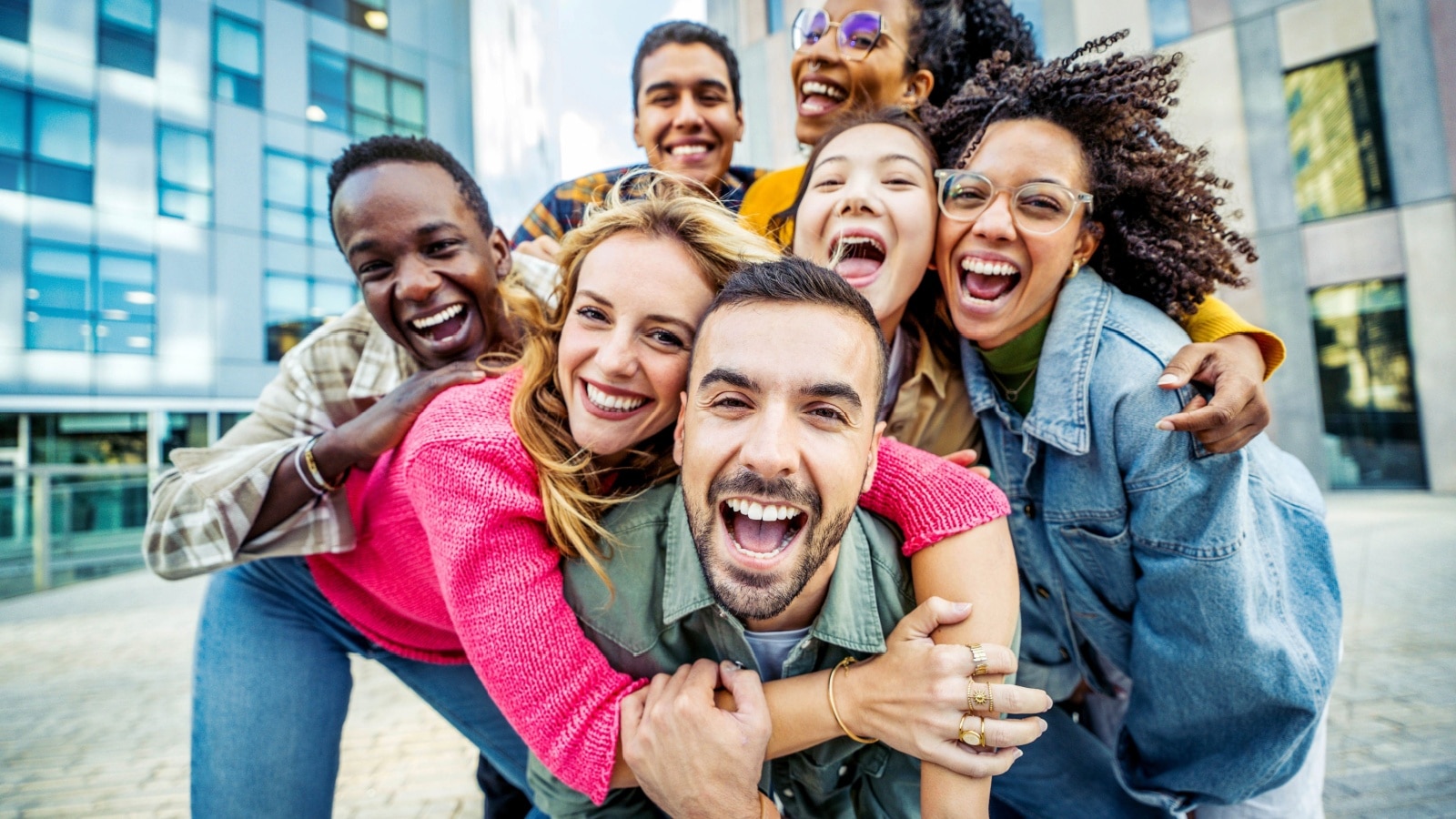 A group of happy friends taking a selfie in the city to represent things to do with friends.