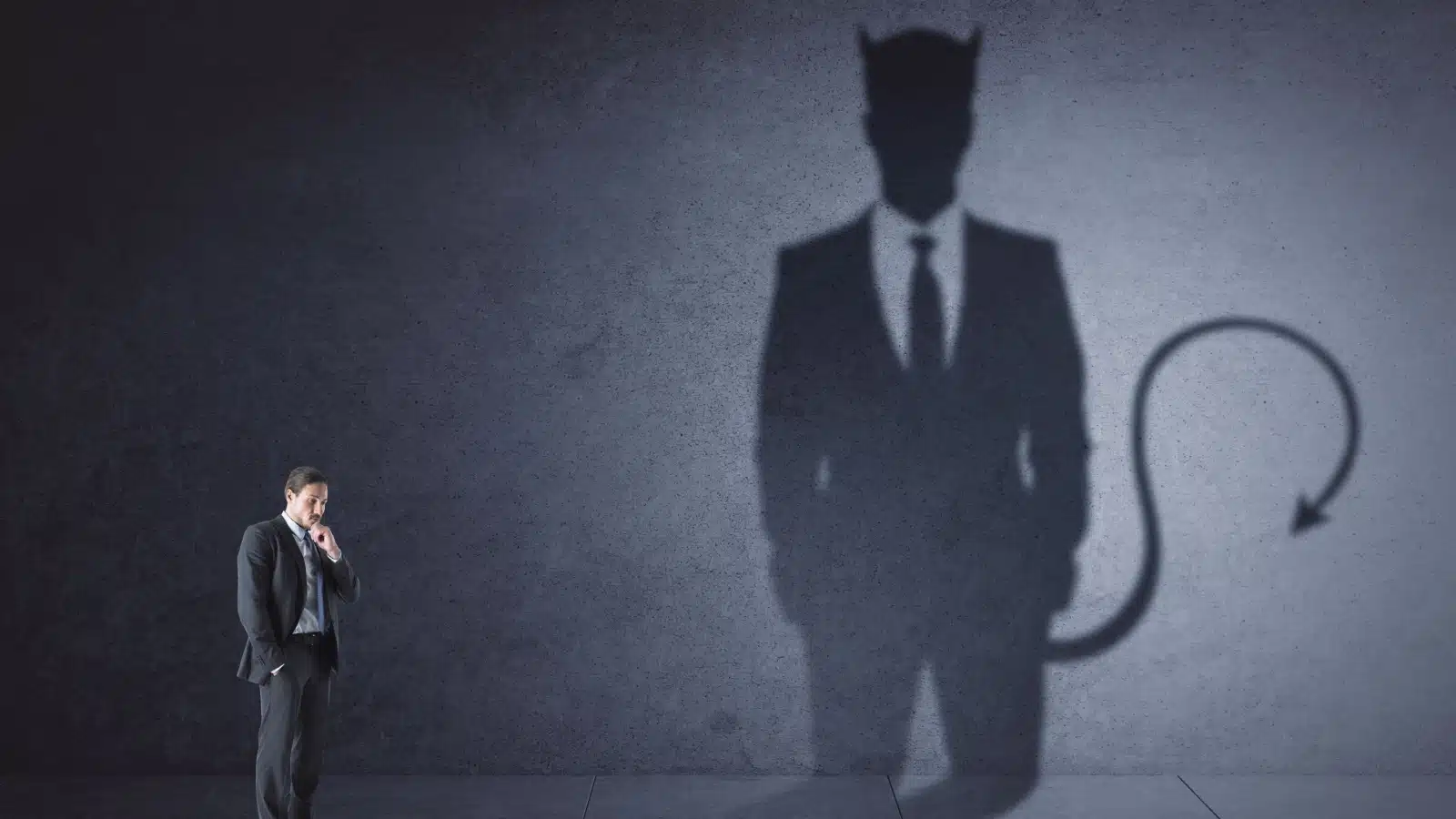 A man's shadow reflects a giant demon, showcasing the internal battle between good and evil inside humanity. 