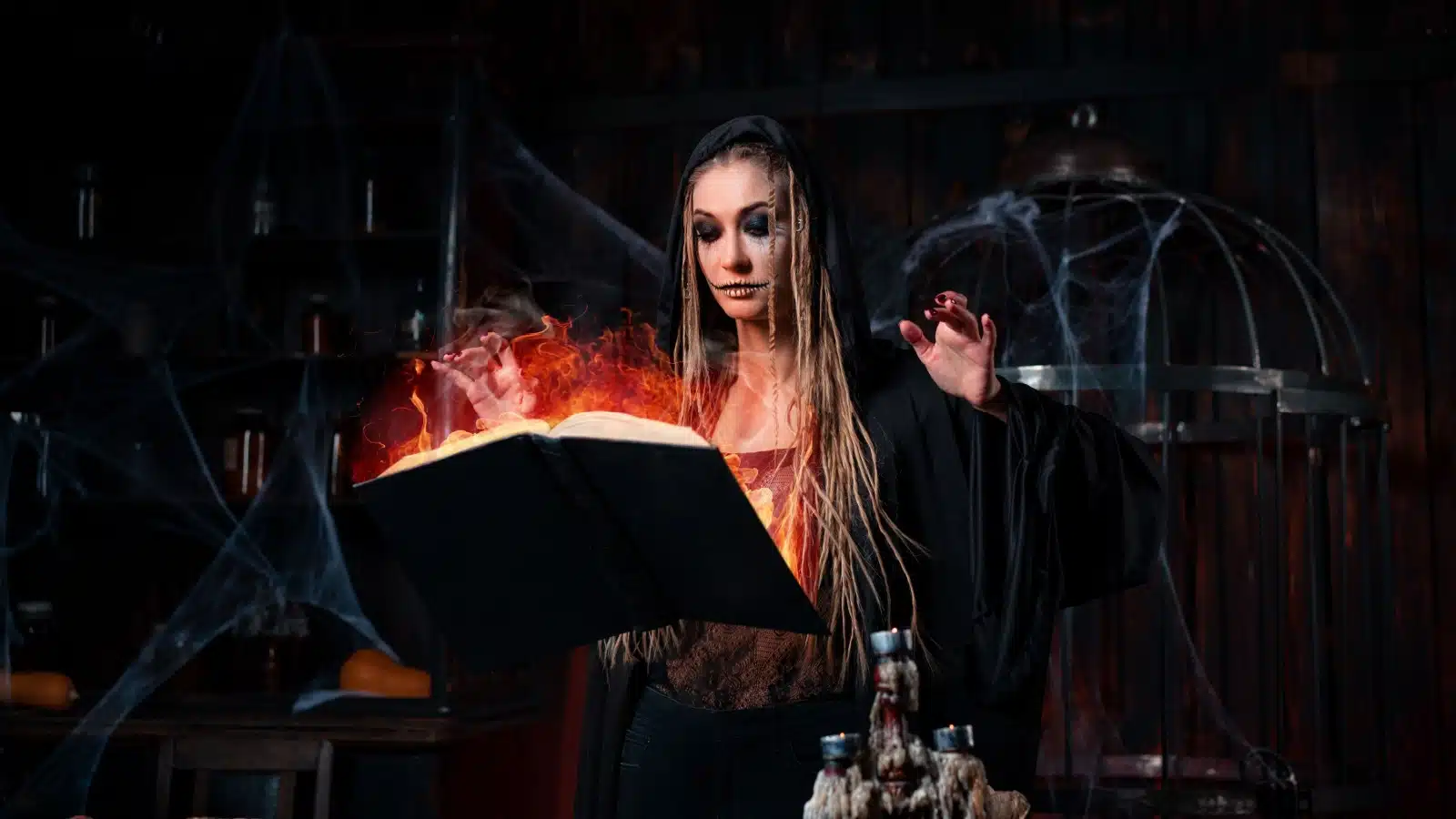 Concept art of an evil witch dressed in black casting a spell from a flaming book of shadows.