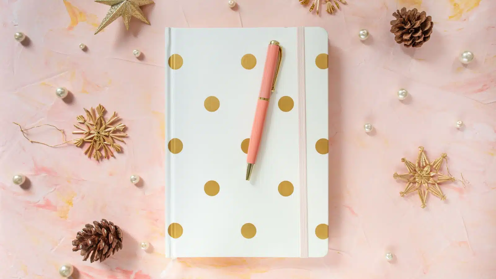 A pretty journal surrounded by cutesy items to represent journal decorations.