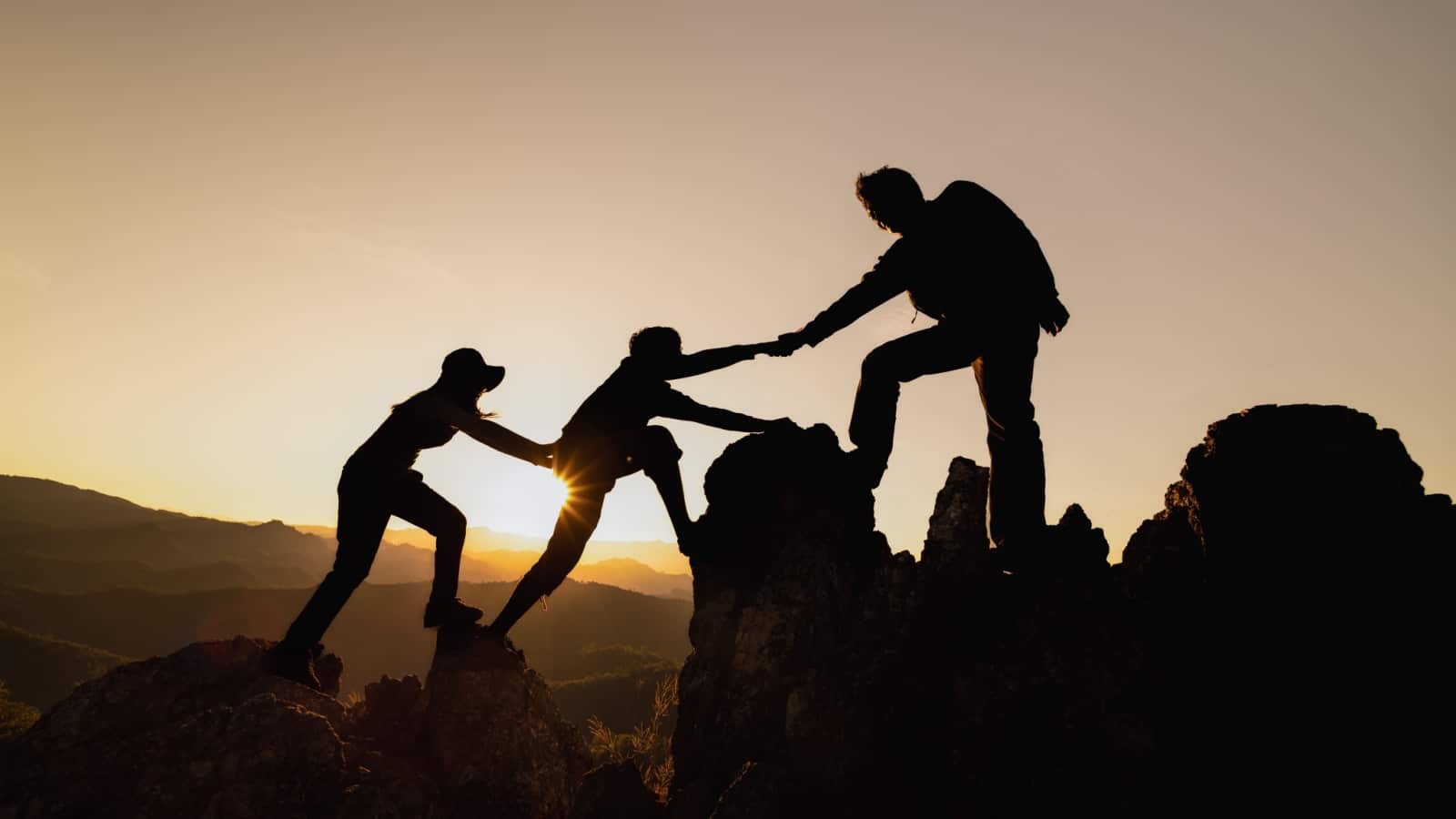 People helping each other climb a mountain, to represent neutral good who is always helping others.