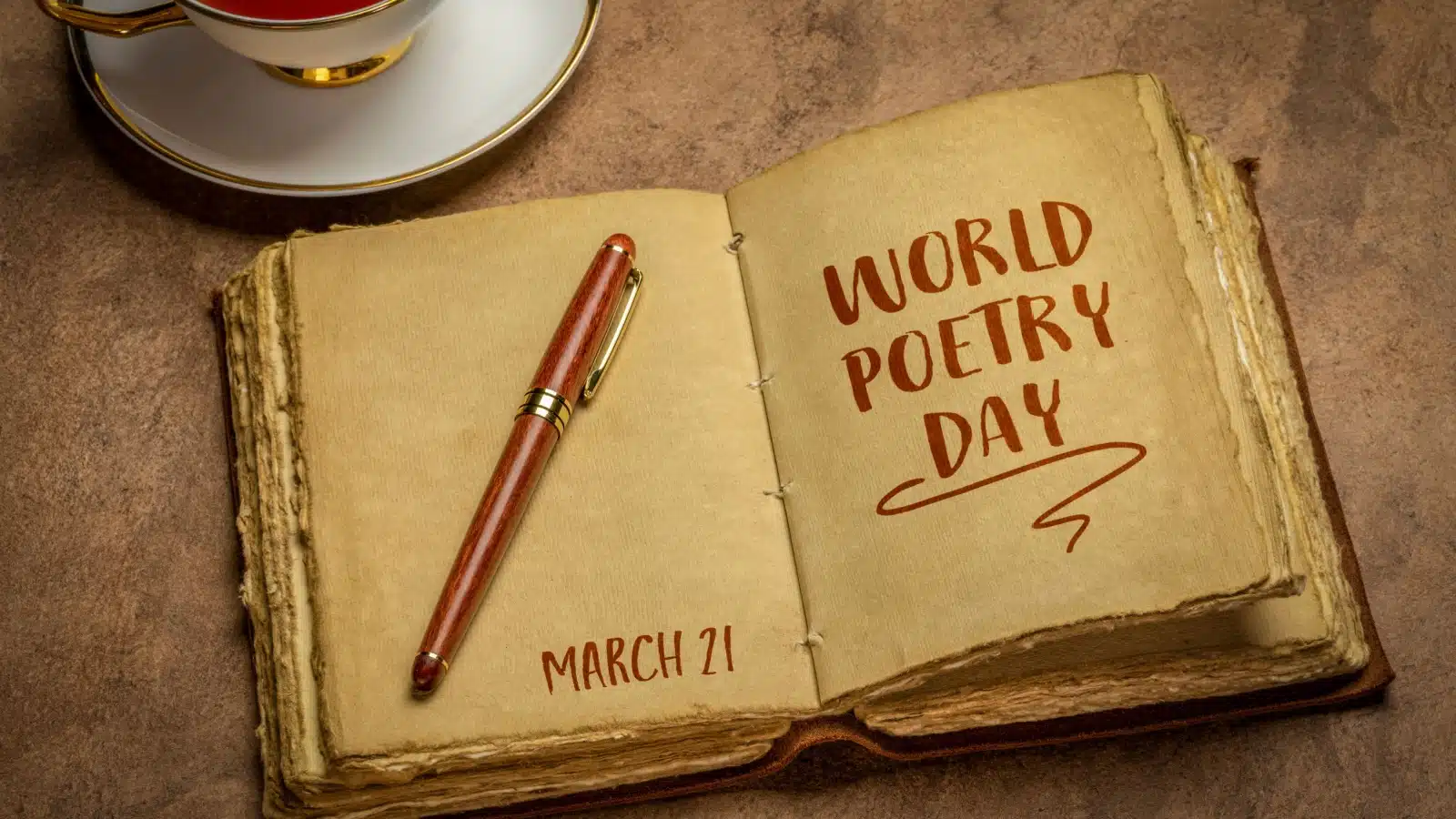 An aged looking journal open to a page that reads "World Poetry Day."