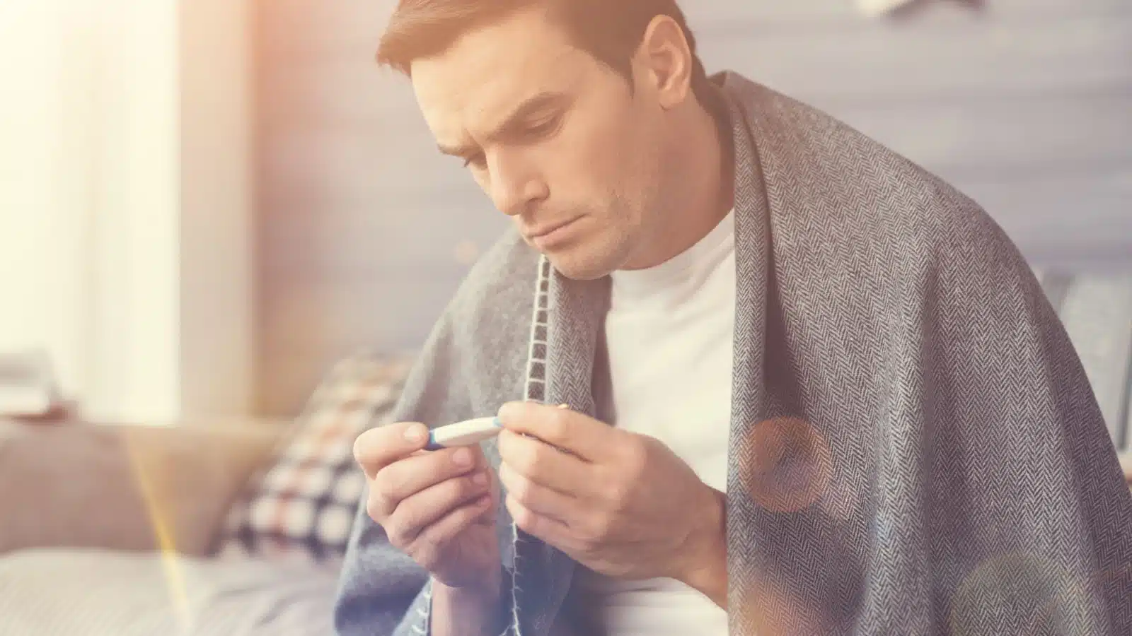 A sick man examines the thermometer. Does he have the privilege of being sick, or does he still have to go to work?