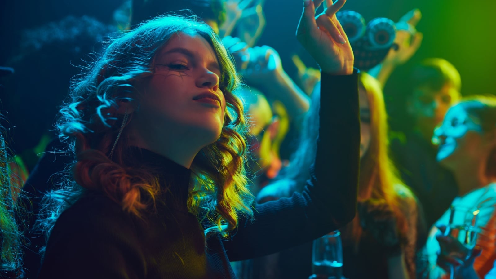 A woman in a club enjoys enchanting music to represent songs about witches.
