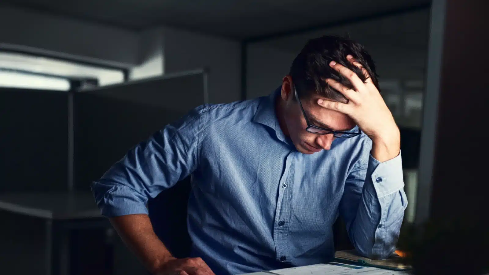 A stressed man who is experiencing burnout at work.