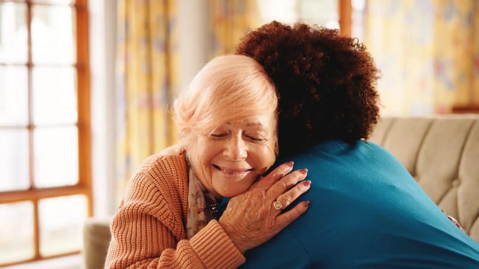 A thankful woman hugs her friend.