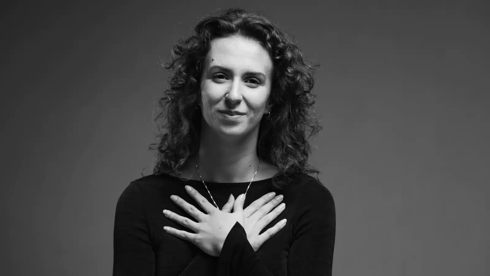 A woman expressing a heartfelt thank you.