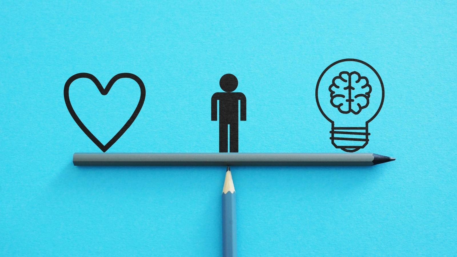 Graphic representing pragmatic vs idealistic. A human icon sits in the center of a balancing beam. A heart icon is on the left, and a brain icon on the right.