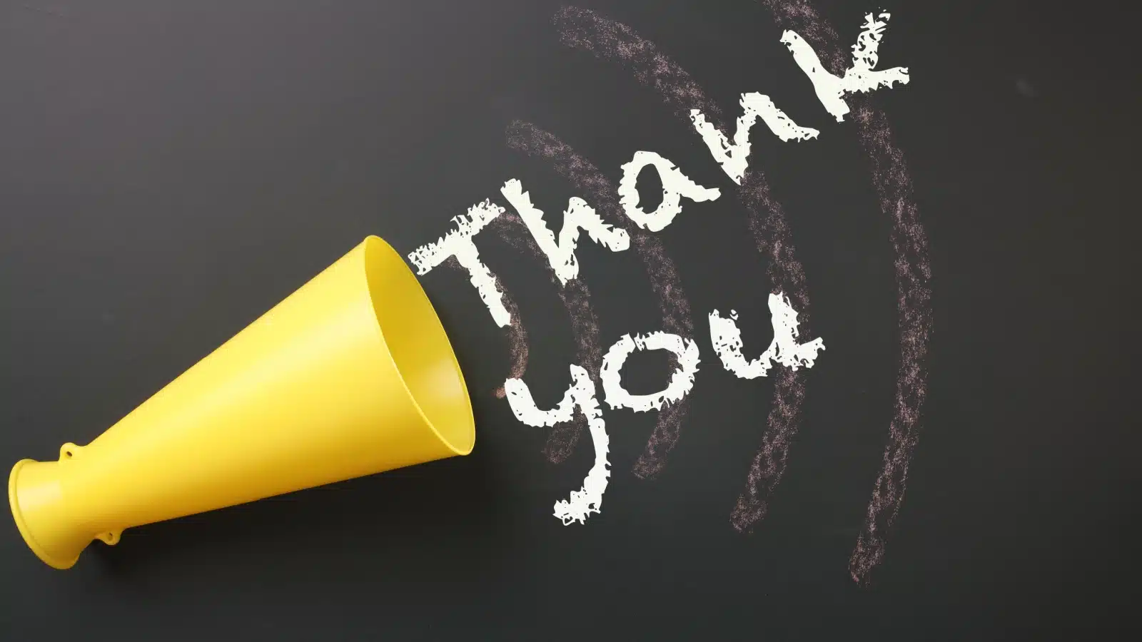 A megaphone with the words "thank you" written in chalk to represent saying thank you out loud.
