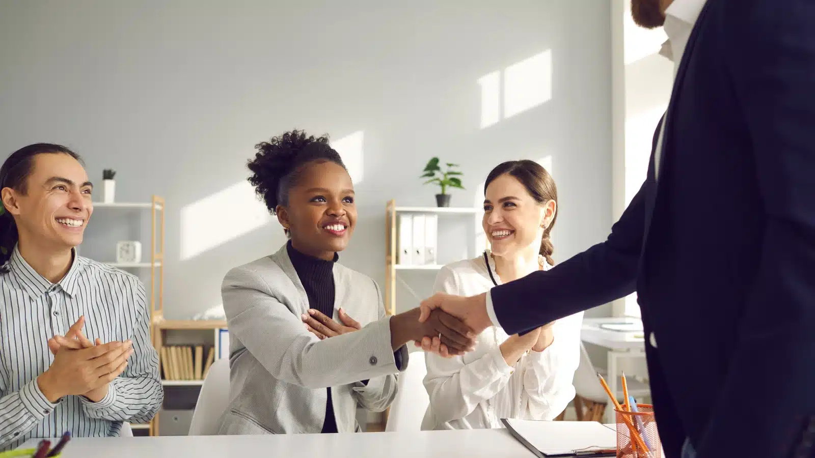 A boss thanks an employee for their hard work.