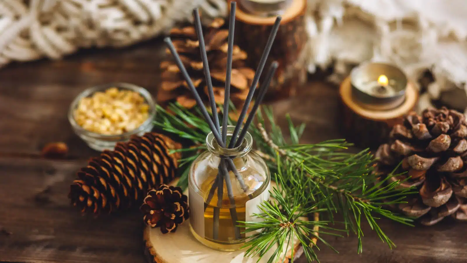 An oil diffuser surrounded by pinecones to represent pine, the top Christmassy smell.