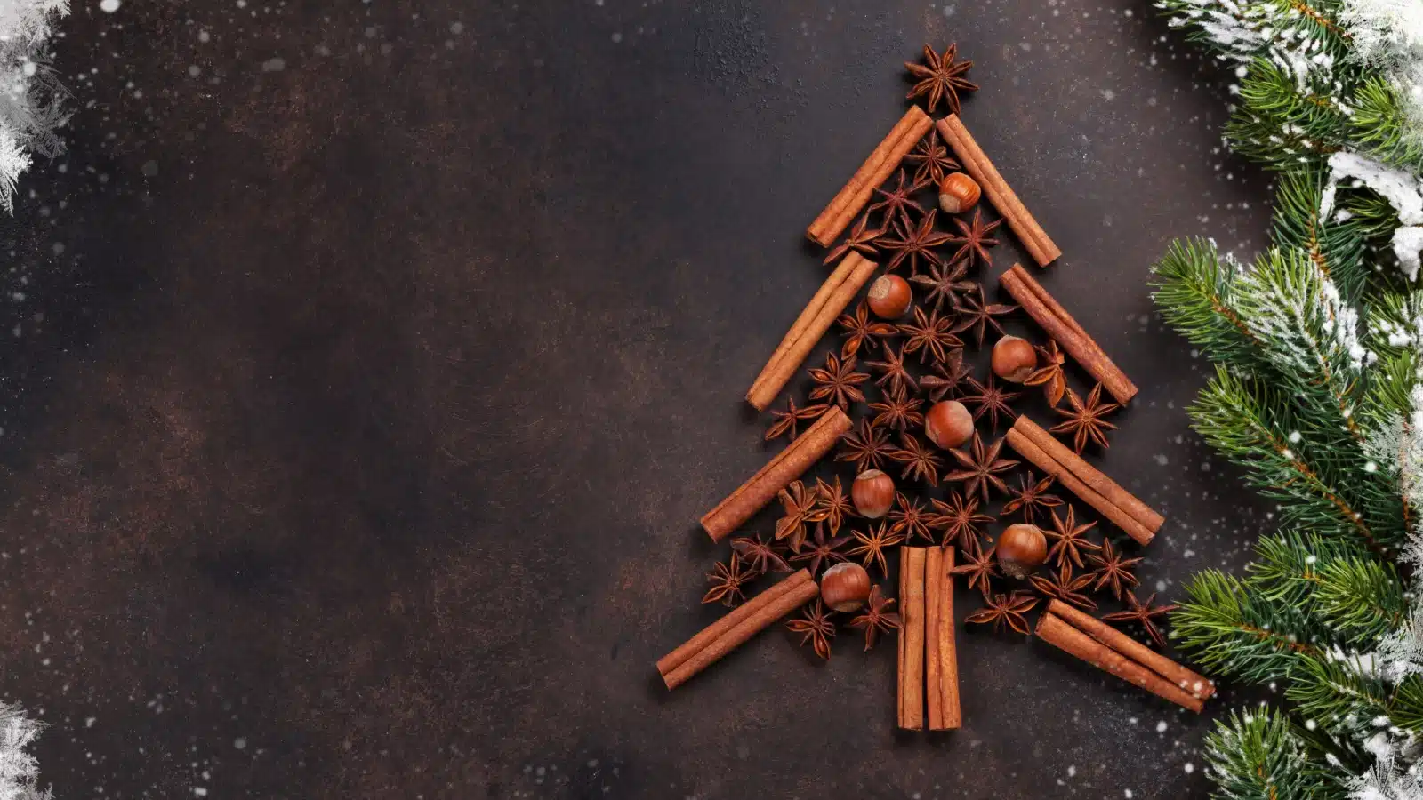 Star anise and cinnamon sticks arranged together to form a Christmas tree, to represent the best Christmas spices.