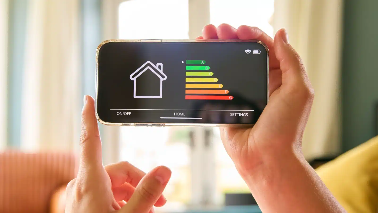 A woman looks at her smart phone app that shows her energy consumption.