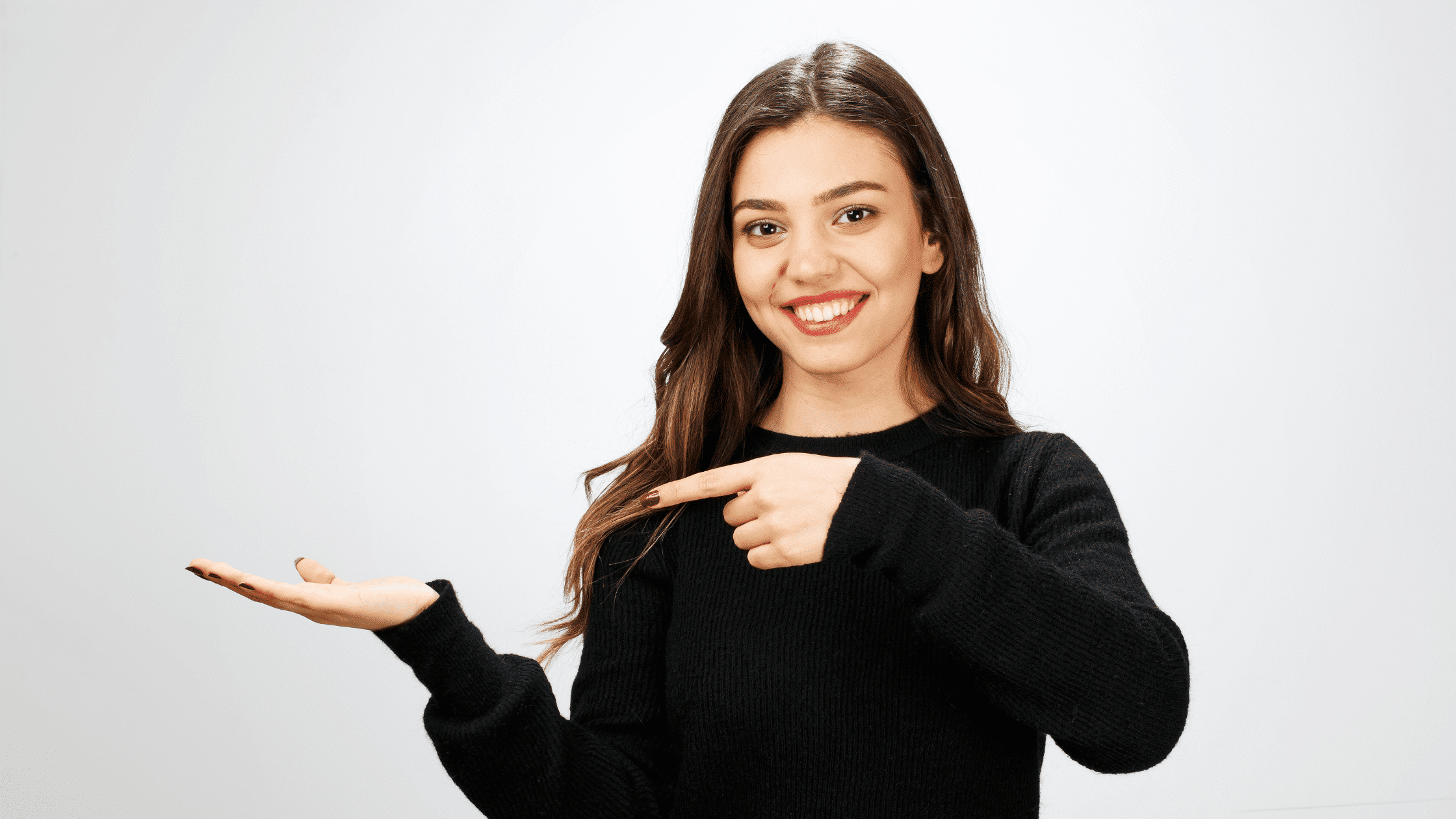 Smiling woman pointing to her hand to represent new habits
