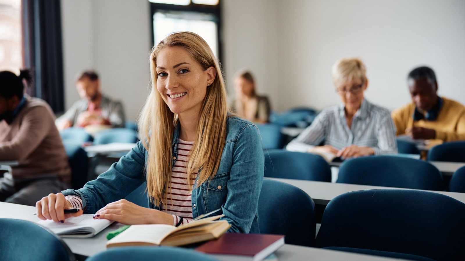 An adult student in a classroom to represent ways to invest in yourself.