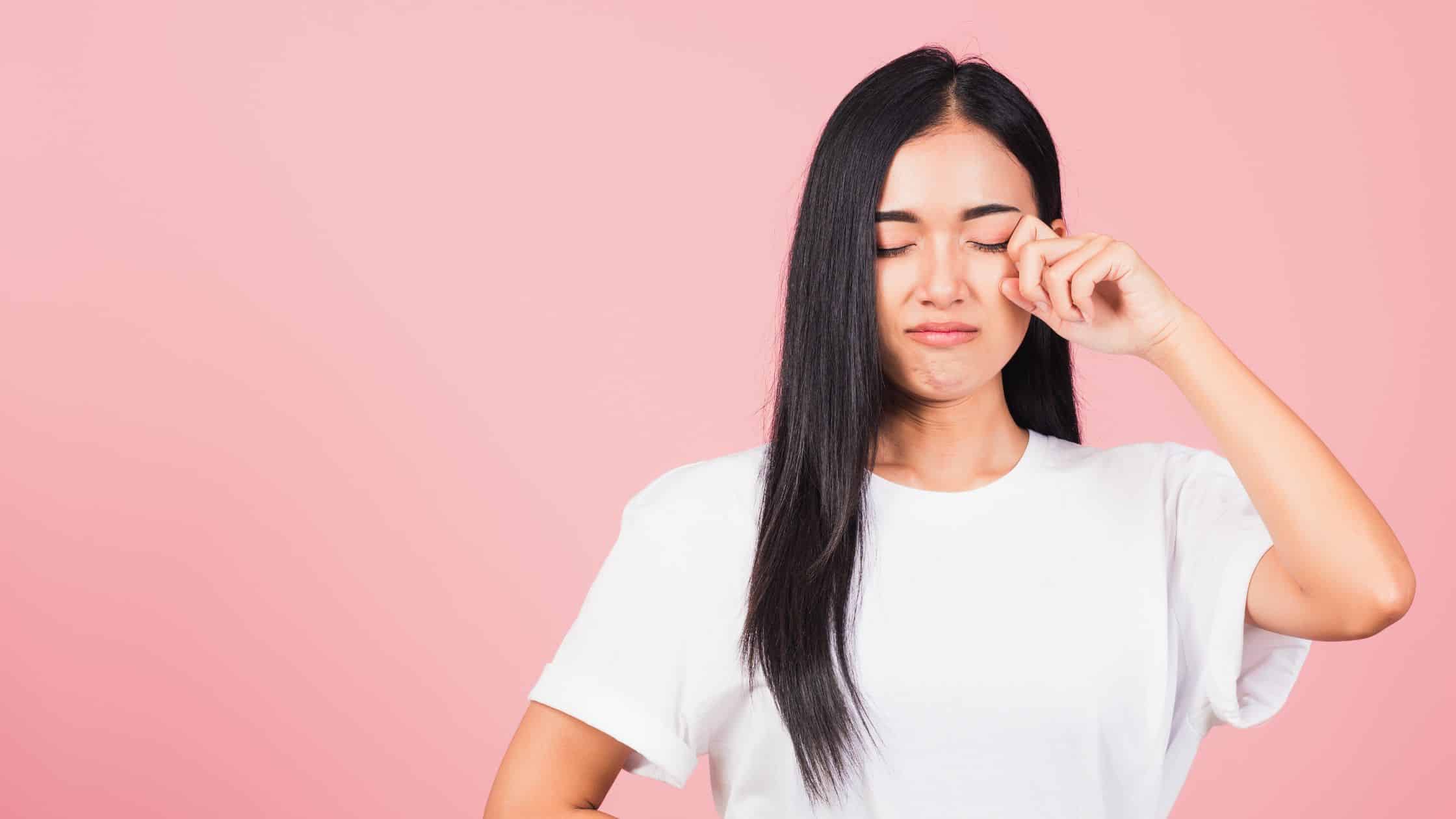 sad woman pretending to wipe a tear