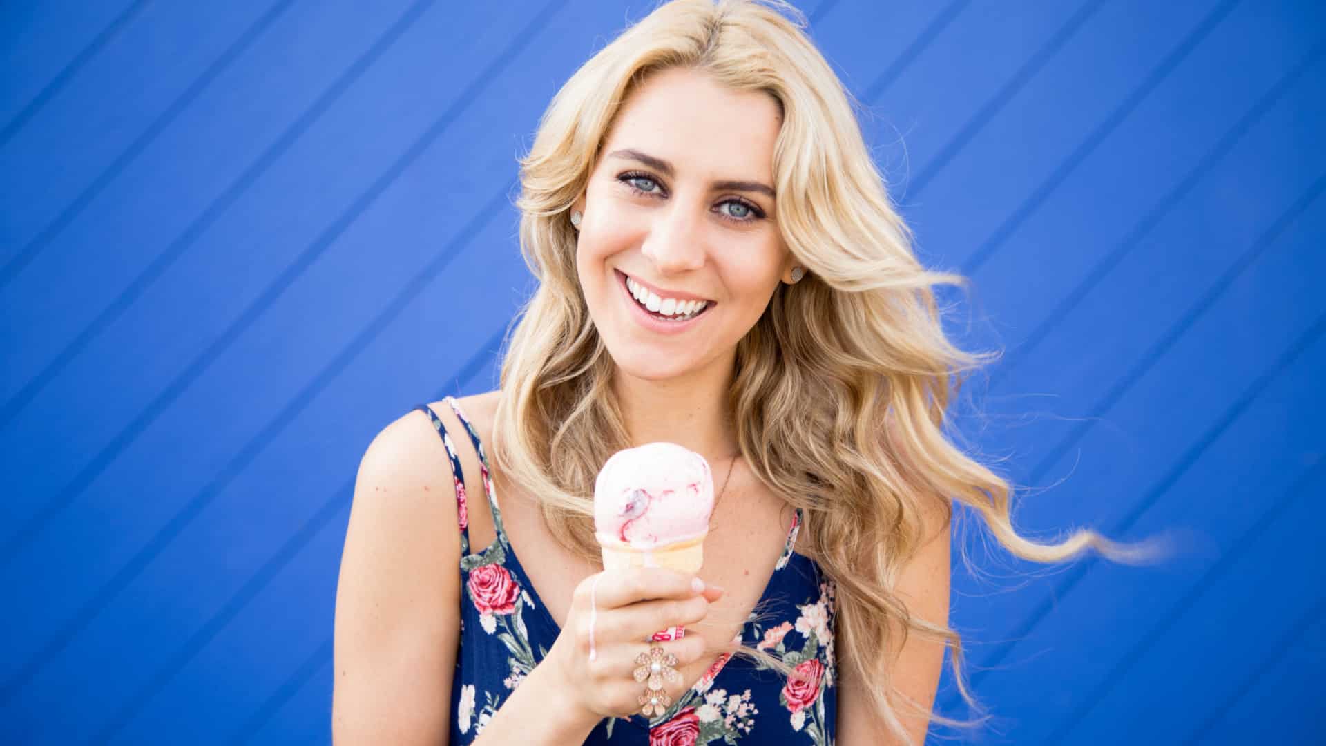 happy young woman holding an ice cream cone