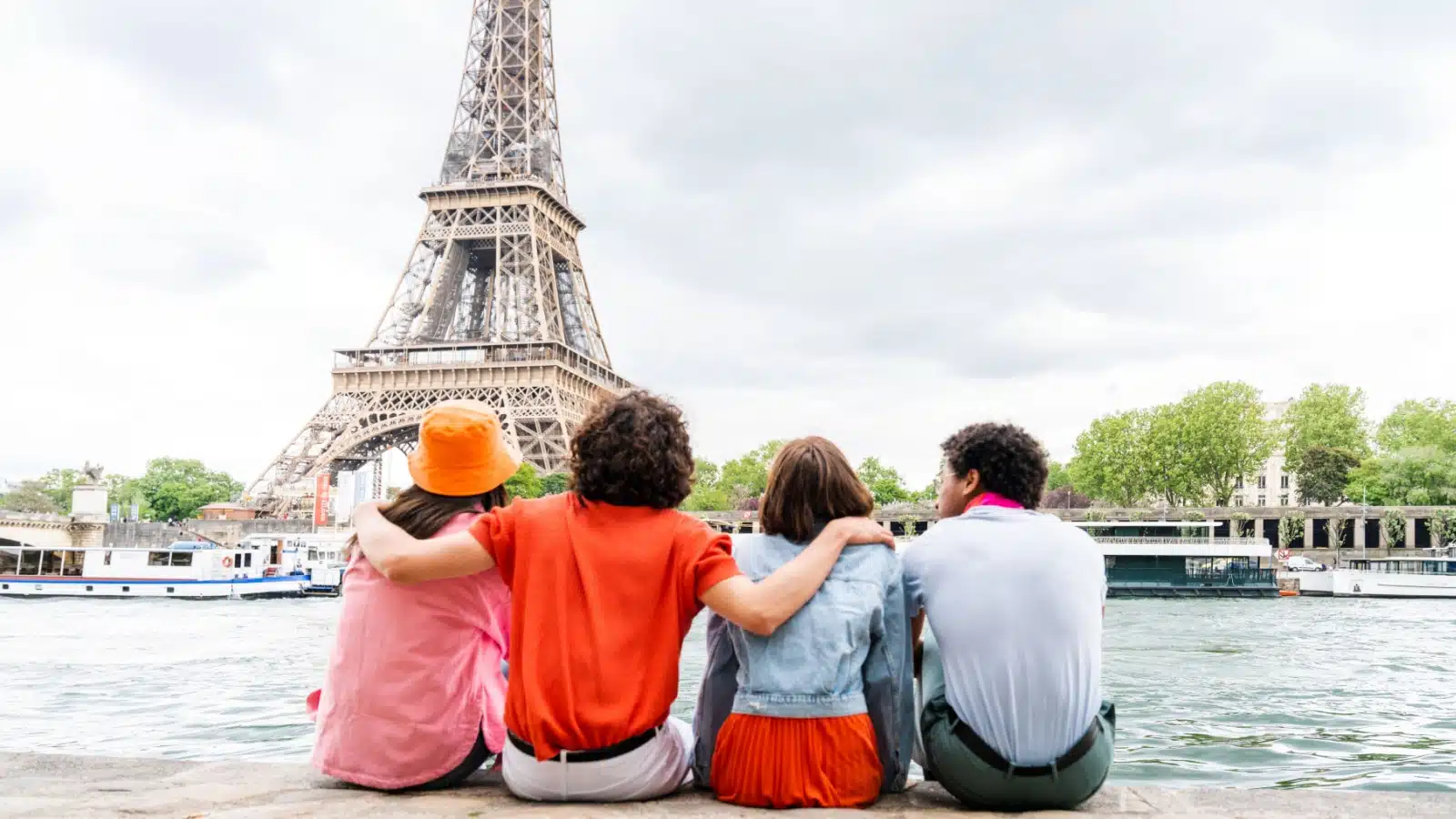 Travelers sitting near the Eiffel Tower in Paris to represent European Habits that give Americans culture shock.