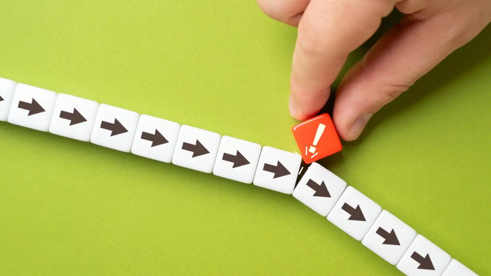 A man puts a tiny nudge in a group of arrows, slightly changing the direction they are moving in. The image represents making small changes to shift the outcome of your life. 