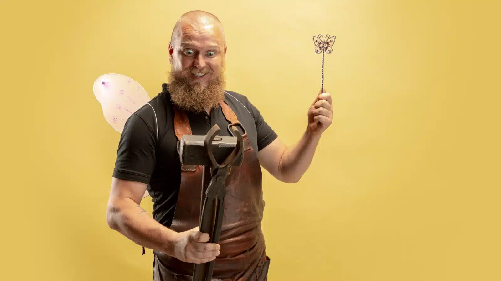 A blacksmith with fairy wings waiting with glee to strike as the good idea fairy.