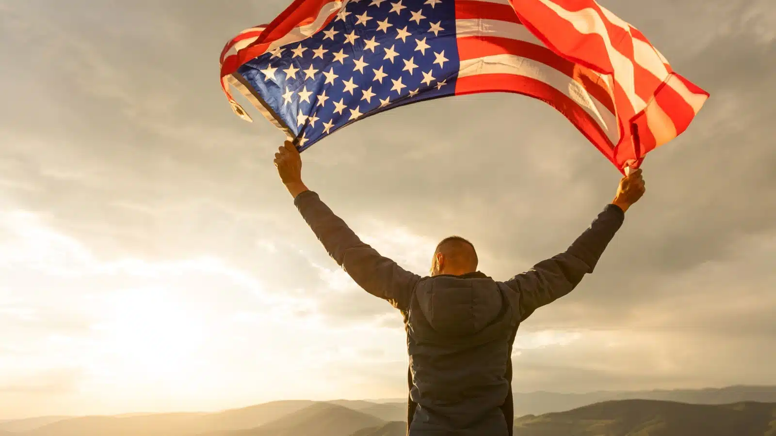 A proud American waves a flag over his head, representing how America is the best countries. But that's not always true, as there are many things other countries do better.