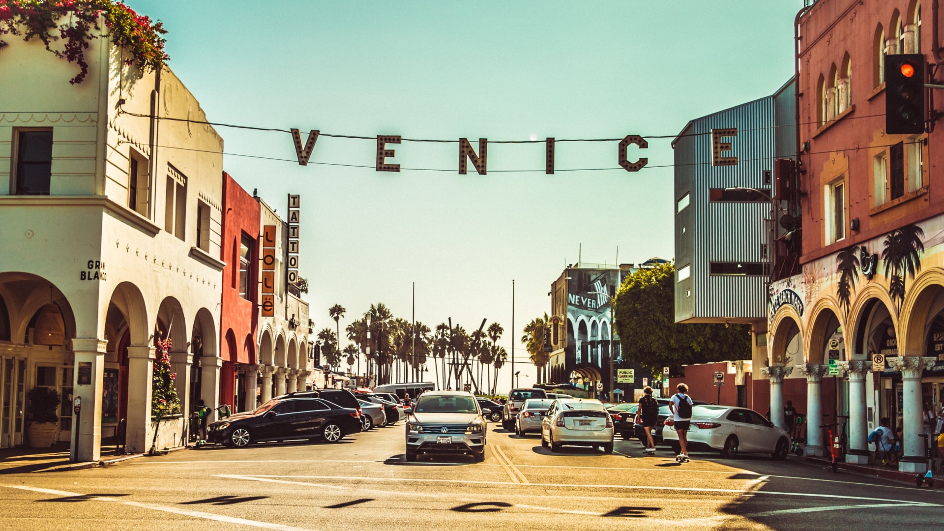 Photo of the Venice sign hanging over the street acting as a gateway to Venice Beach