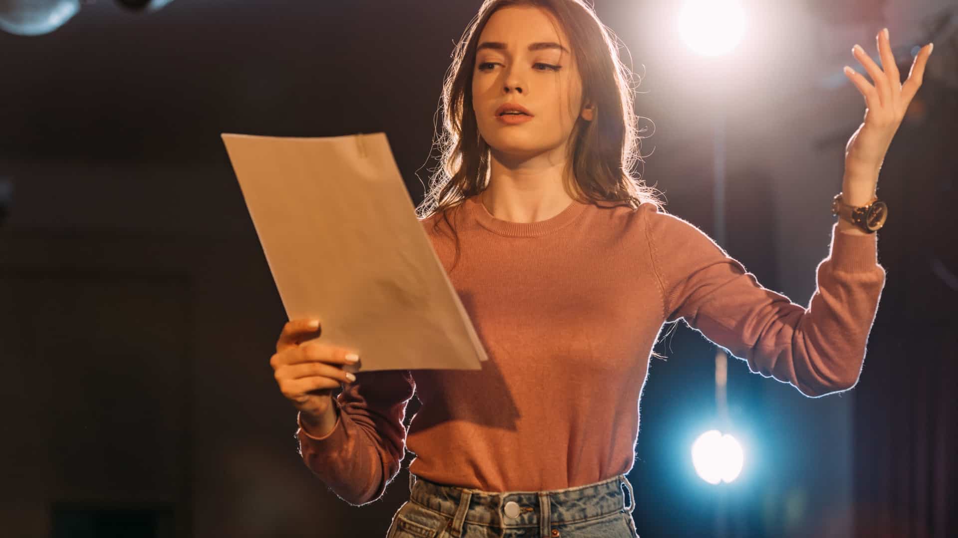 woman reading a script on stage
