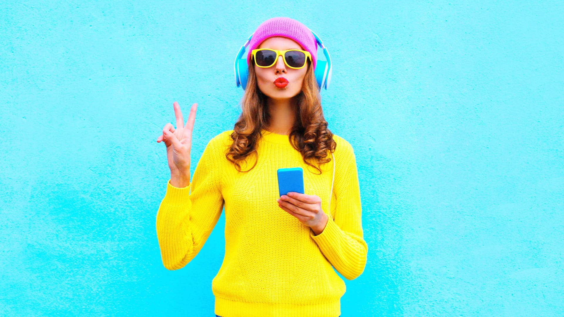 Cool woman dressed in trendy clothes on a light blue background