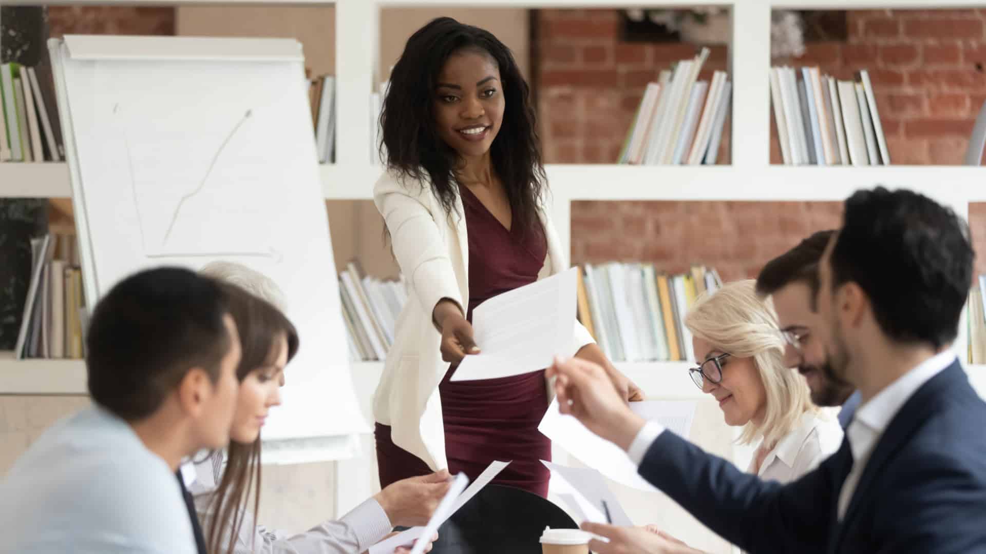 Woman handing a project to her collegue