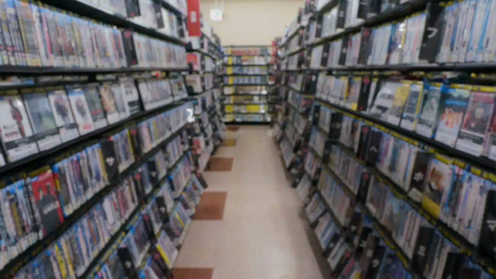 Shelves full of movies in a video rental store remind us of the 1990s.
