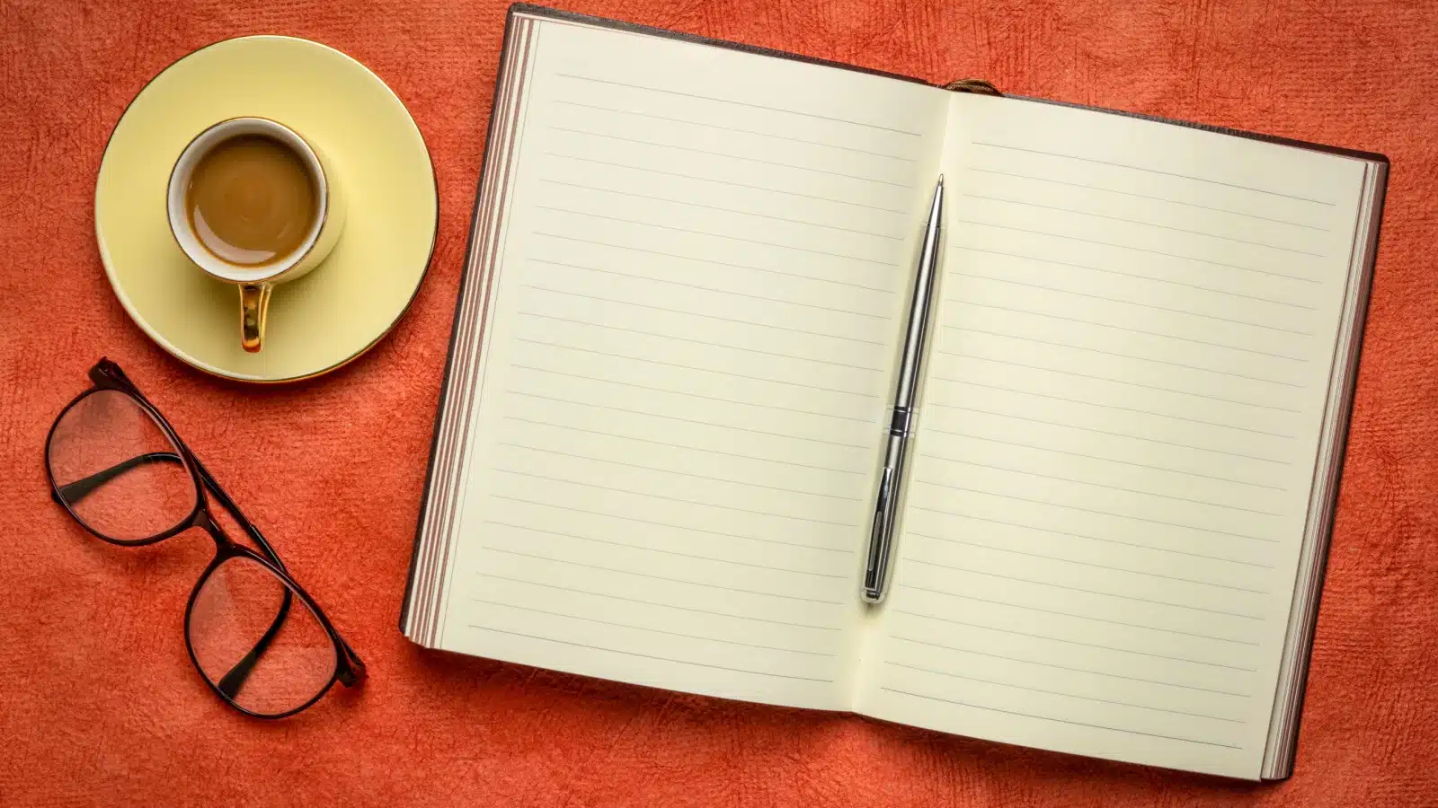 A ruled journal open to show the lines on the pages inside.