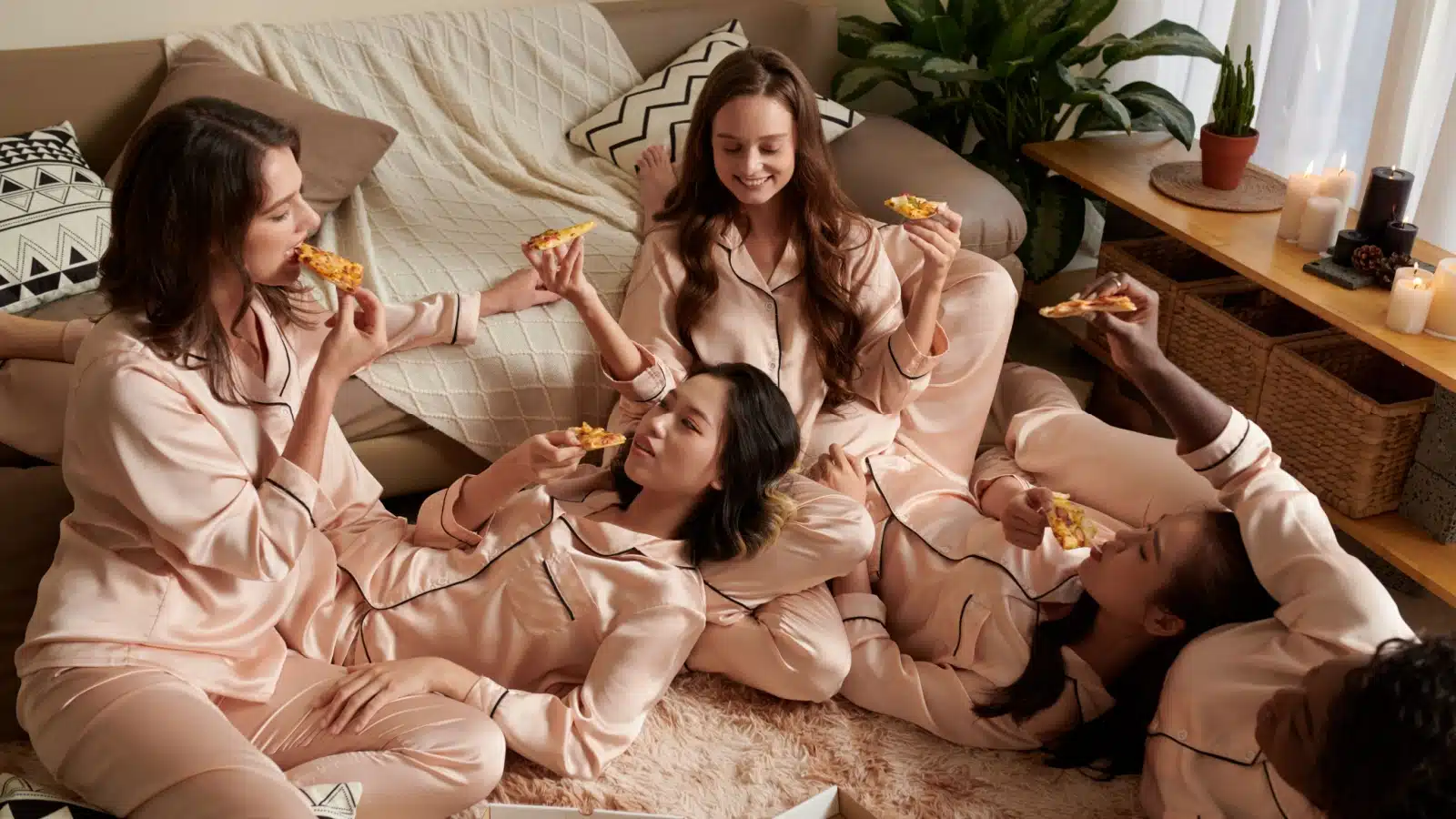 A group of girl friends wearing matching pajamas at a sleepover party.