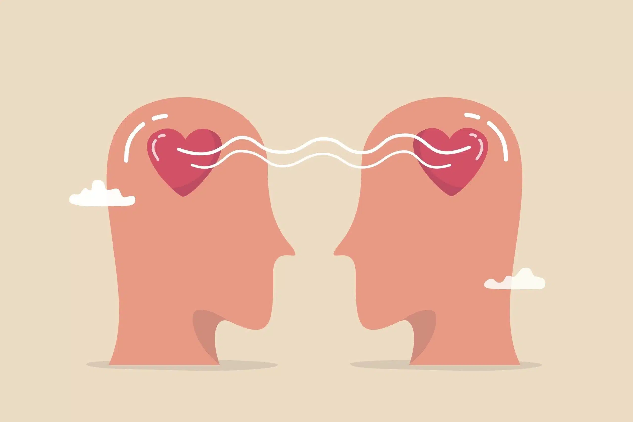 Illustration showing what empathy means. Two heads have hearts instead of brains, the hearts are connected by waving lines representing energy.