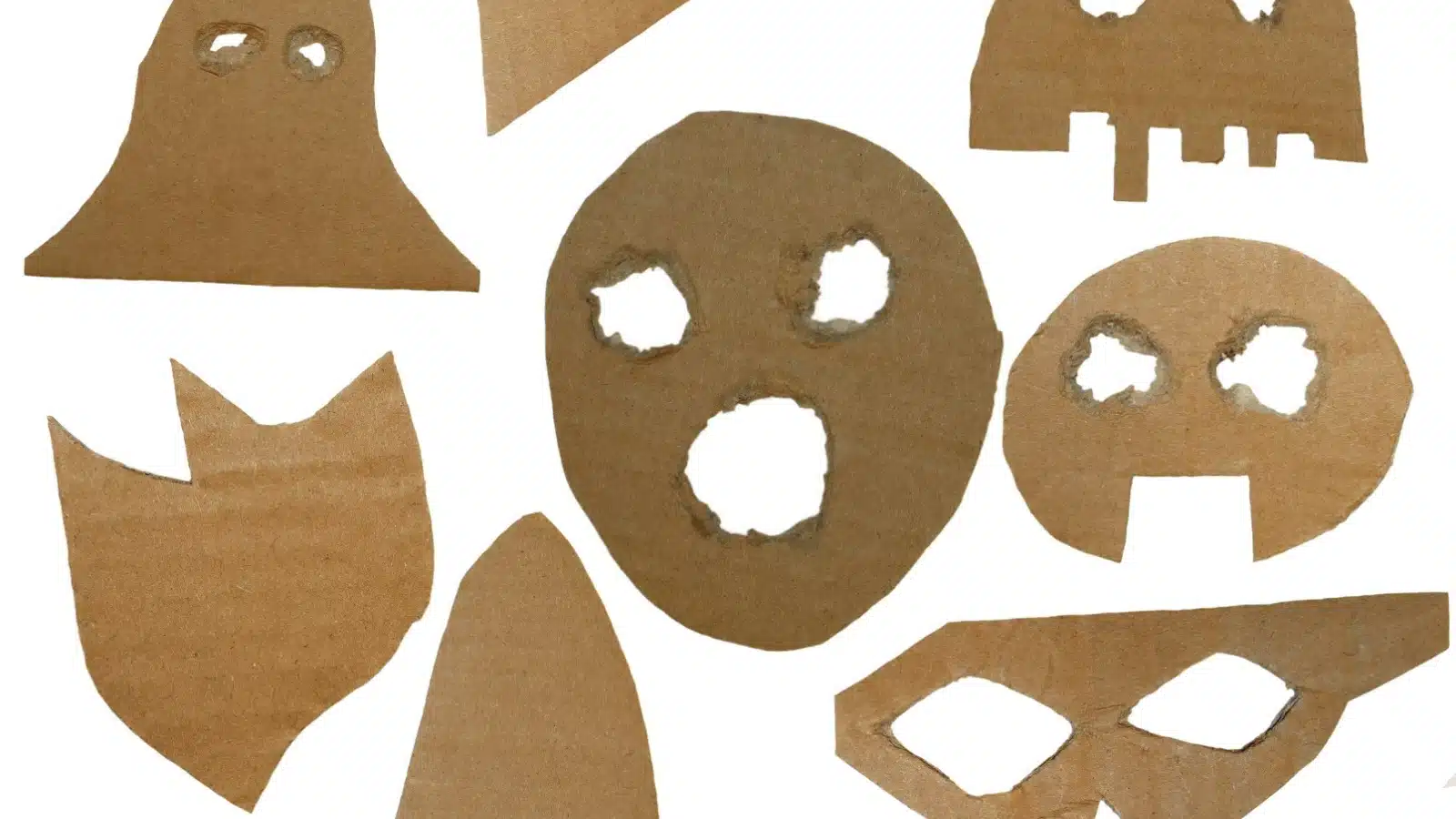 Masks cut out of cardboard to represent papier mache molds.